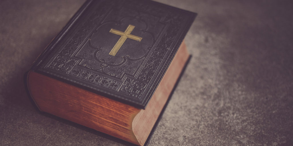 black-Bible-on-gray-surface